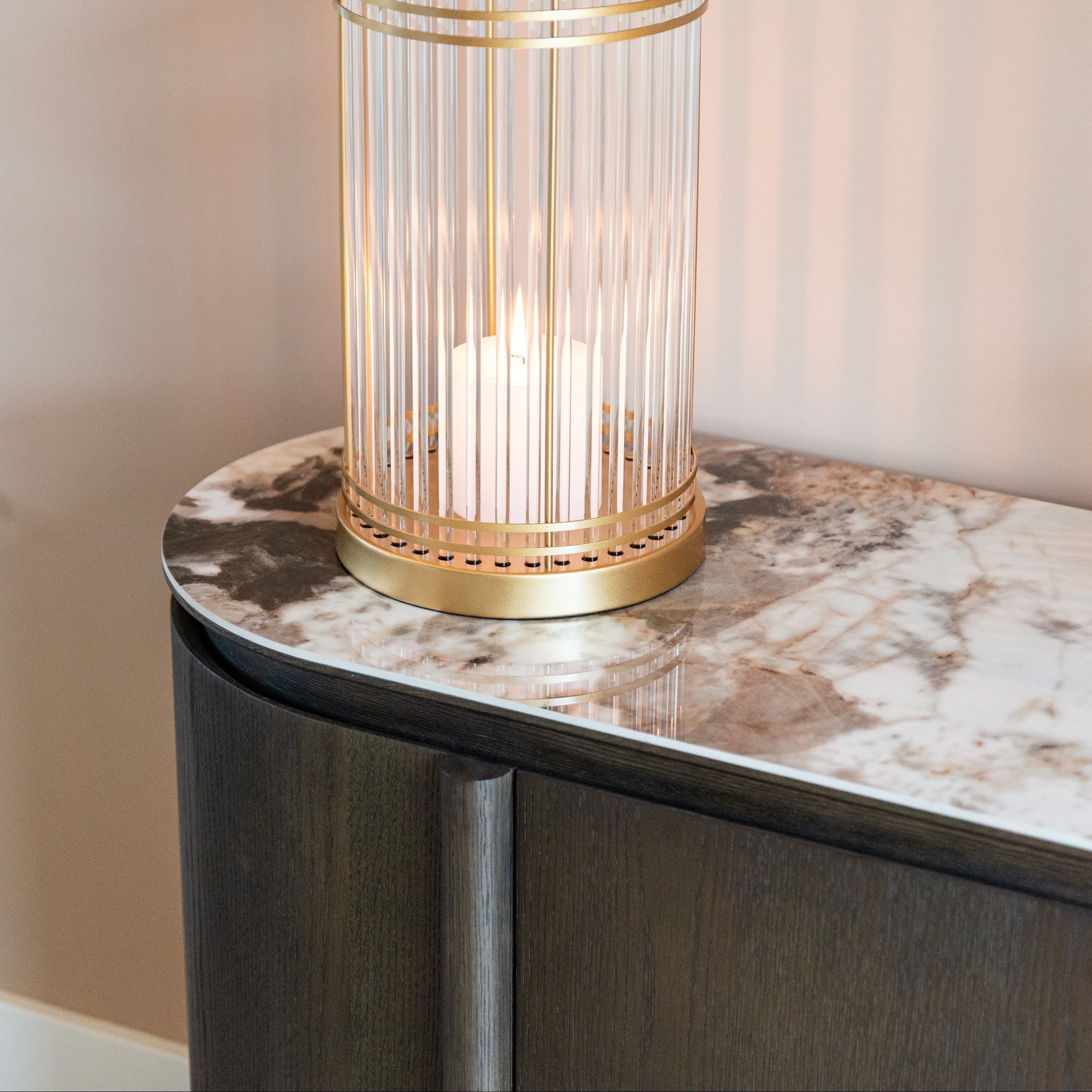 Decorative table lamp with gold cage design on a marble surface
